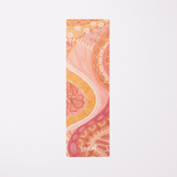 Full view of the Indie eco-friendly yoga mat by Yogat, featuring an intricate artistic design in warm hues of orange, pink, and yellow, made with sustainable materials