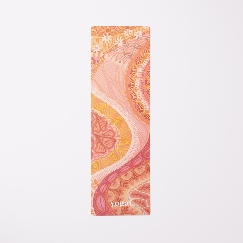 Full view of the Indie eco-friendly yoga mat by Yogat, featuring an intricate artistic design in warm hues of orange, pink, and yellow, made with sustainable materials